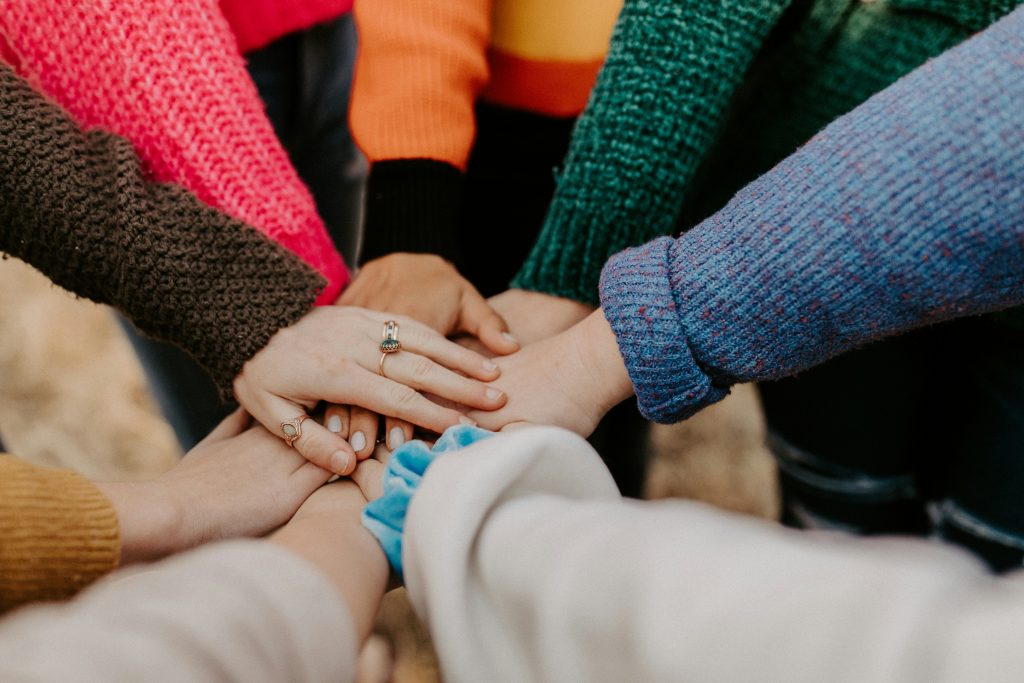 hands on top of one another in a circle