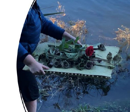 A person holding a tray of flowers